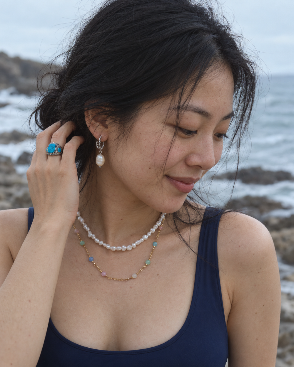 Sea Nymphs jewellery worn in a natural beachside lifestyle photograph.