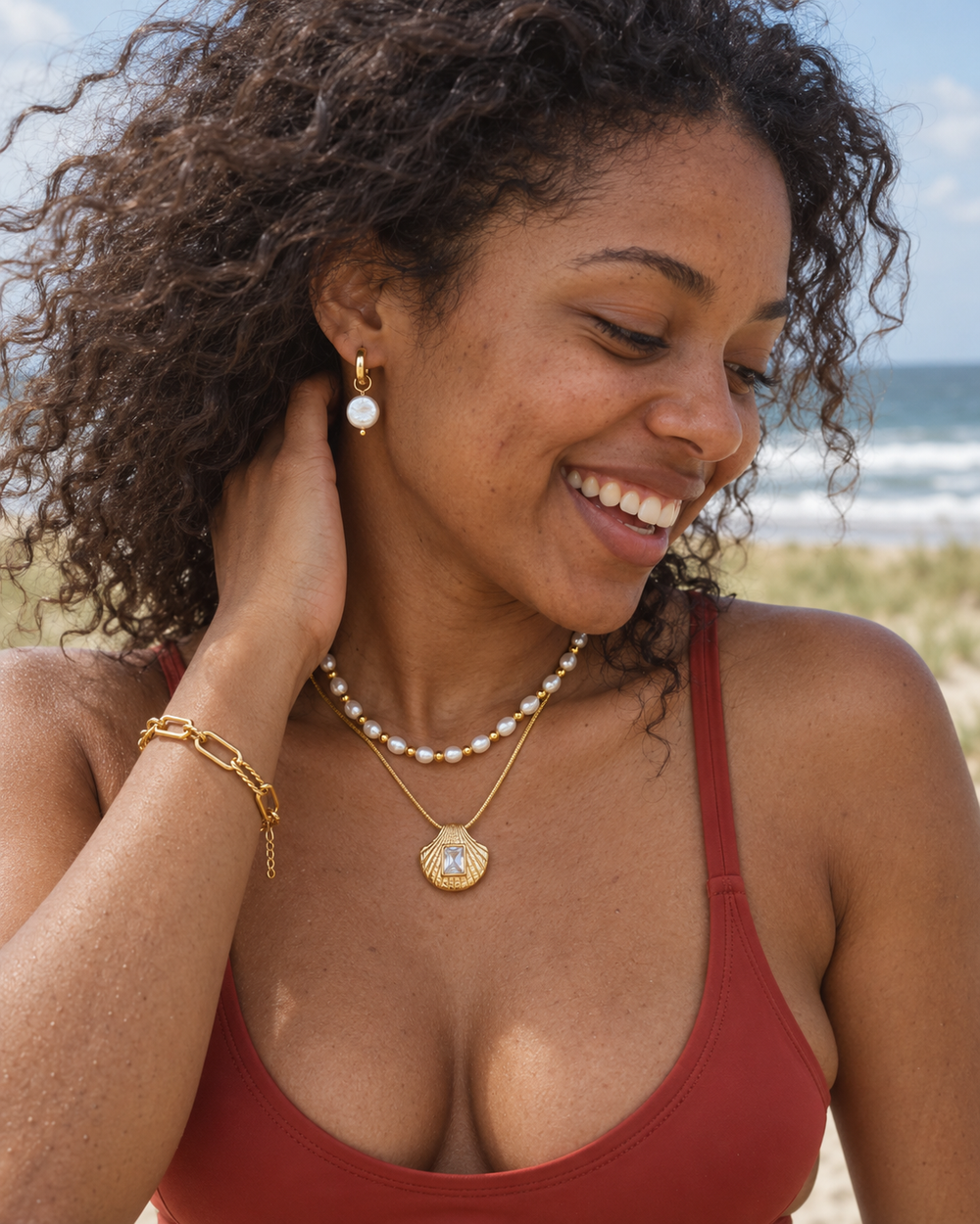 Sea Nymphs jewellery worn in a natural beachside lifestyle photograph.