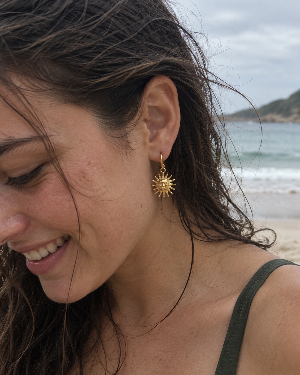 Candid beachside lifestyle portrait featuring Sea Nymphs Sunbeam charm hoop earrings.
