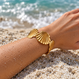 Fan Tide shell cuff in a beachside setting