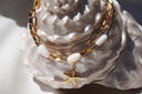 Alternate view: gold-tone link bracelet with white oval beads and a hanging starfish motif.