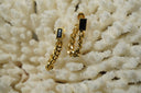 Gold-tone stud earrings with black rectangular faces and hanging curb-chain loops.