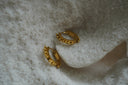 Gold-tone flat-band hoop earrings edged with evenly spaced spherical dots.
