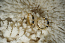 Alternate view: gold-tone circular hoop earrings with black bands across their front sections.