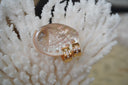 Alternate view: broad gold-tone hoop earrings with clear accents arranged in crosses on the front.