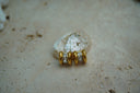 Gold-tone hoops with clear square accents set between rounded parallel edges.