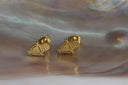 Gold-tone microphone-shaped stud earrings with dotted grille details and curved stand outlines.