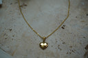 Gold-tone fine chain necklace with a heart pendant covered in square, chequered facets.