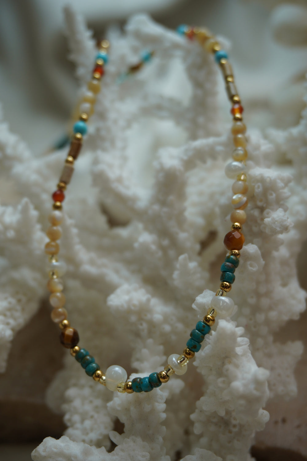 Alternate view: mixed-bead necklace with cream, white, blue and brown beads, cylindrical sections and gold-tone spacers.