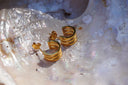 Alternate view: gold-tone open hoop earrings formed from three parallel bands, with posts and butterfly backs.
