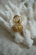 Alternate view: gold-tone hoops with open sunburst disc charms, dotted borders and round clear centres.