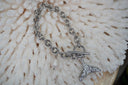 Alternate view: silver-tone chain bracelet with a textured mermaid-tail charm, pale drop and ring-and-bar fastening.