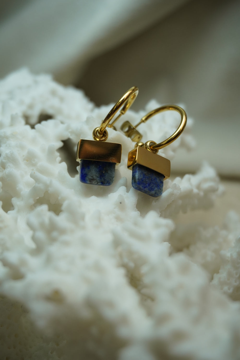 Alternate view: gold-tone open hoop earrings with rounded ends and mottled blue square drops.