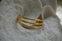 Alternate view: gold-tone open cuff with three parallel bamboo-like rails and open spaces.