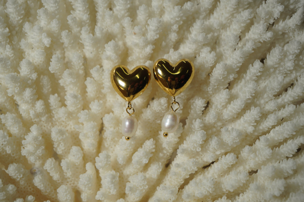 Alternate view: rounded gold-tone heart stud earrings with white oval bead drops.
