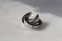 Alternate view: silver-tone hoop earrings with smooth flat bands and visible hinged openings.