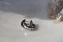 Silver-tone hoop earrings with smooth flat bands and visible hinged openings.