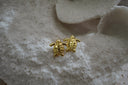 Gold-tone turtle stud earrings with patterned bodies and outstretched flippers.