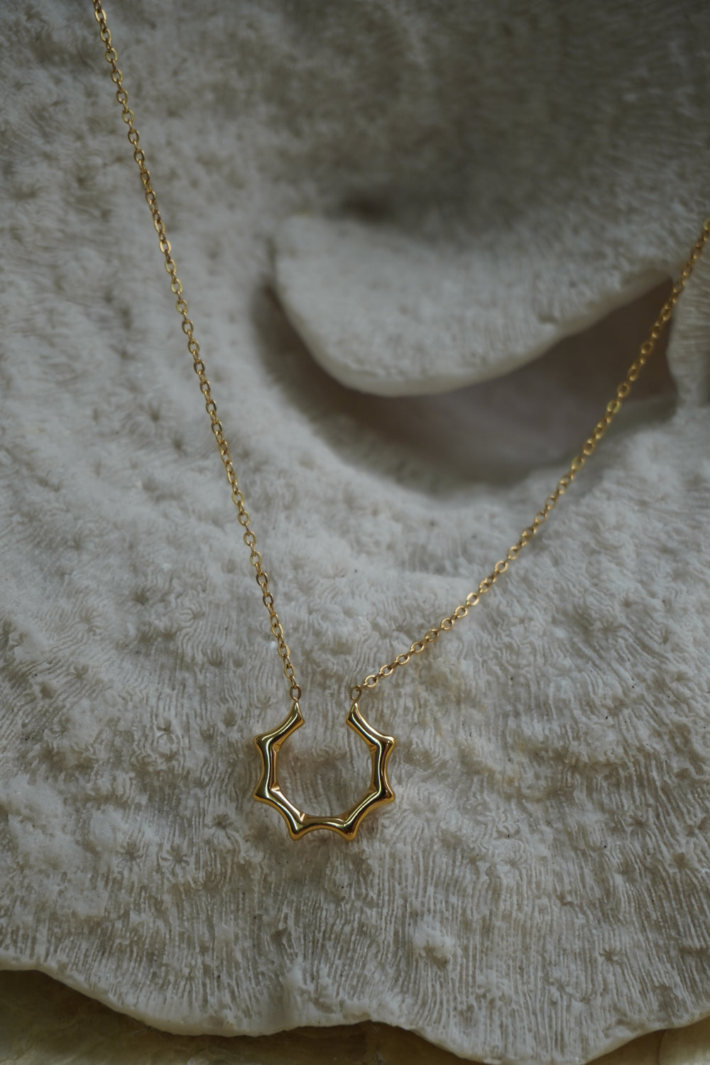 Alternate view: gold-tone necklace with an open scalloped halo shape attached to a fine chain.