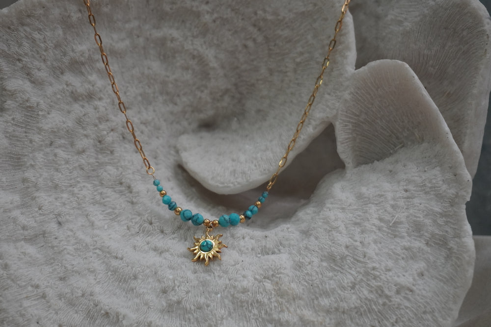Alternate view: gold-tone elongated-link necklace with blue beads, gold-tone spacers and a blue-centred sunburst pendant.