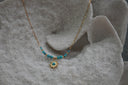Alternate view: gold-tone elongated-link necklace with blue beads, gold-tone spacers and a blue-centred sunburst pendant.