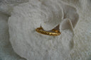 Alternate view: gold-tone open cuff with an uneven rippled surface and rounded ends.
