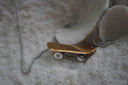 Alternate view: skateboard necklace with a gold-tone deck, silver-tone wheel details and a silver-tone chain.