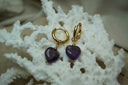 Alternate view: gold-tone hoop earrings with deep purple heart-shaped bead drops and small gold-tone ball details.