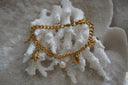 Gold-tone curb-chain bracelet with starfish, shell motifs and a white oval drop.