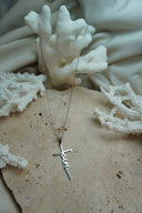 Silver-tone fine chain necklace with a cut-out faith-script pendant incorporating a cross-like outline.