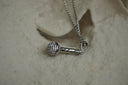 Alternate view: silver-tone necklace with a miniature microphone pendant and bright decorative details.