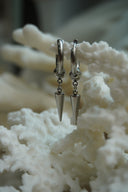 Alternate view: silver-tone hoop earrings with rounded connectors and slim tapered pointed drops.