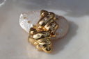 Alternate view: gold-tone spiral-shell stud earrings with pointed tips and scattered round clear accents.