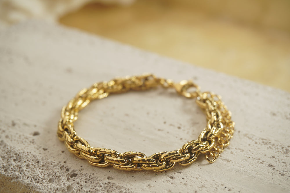 Alternate view: gold-tone bracelet with chunky interlocking oval links, diagonal markings and an extension chain.
