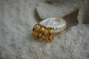 Alternate view: gold-tone open hoop earrings with three curved bands and a central row of clear square accents.
