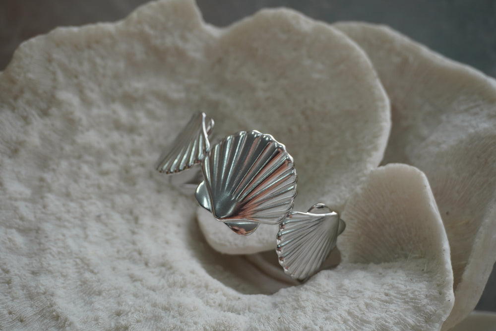 Silver-tone cuff with large ridged fan-shell forms.