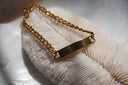 Gold-tone chain bracelet with a plain rectangular centre bar.