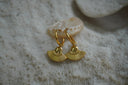 Gold-tone hoops with hanging fan charms, radiating ribs and a dotted curved border.