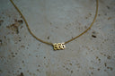 Alternate view: gold-tone fine chain necklace with cut-out 666 numerals in pointed lettering.
