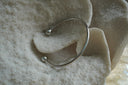 Alternate view: silver-tone open cuff with a smooth rounded band and spherical end caps.
