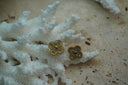 Gold-tone four-lobed earrings with clear accents, dotted borders and rounded centres.