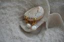 Gold-tone smooth hoops with rounded white bead drops and small gold-tone tips.