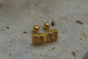 Gold-tone square studs with four round faceted accents, dotted borders and ribbed edges.