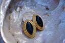 Alternate view: earrings with glossy black pointed-oval centres and rope-like gold-tone borders.