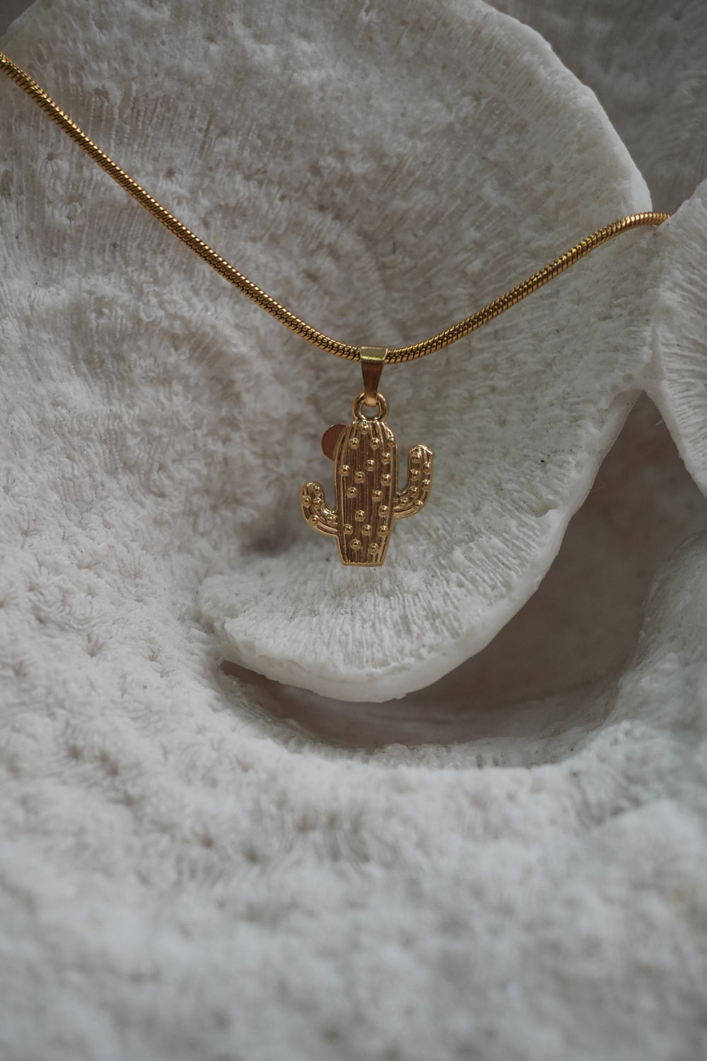 Alternate view: gold-tone necklace with a ridged, dotted cactus pendant on a close-linked chain.