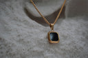 Alternate view: gold-tone chain necklace with a black square pendant, clipped corners and a smooth border.