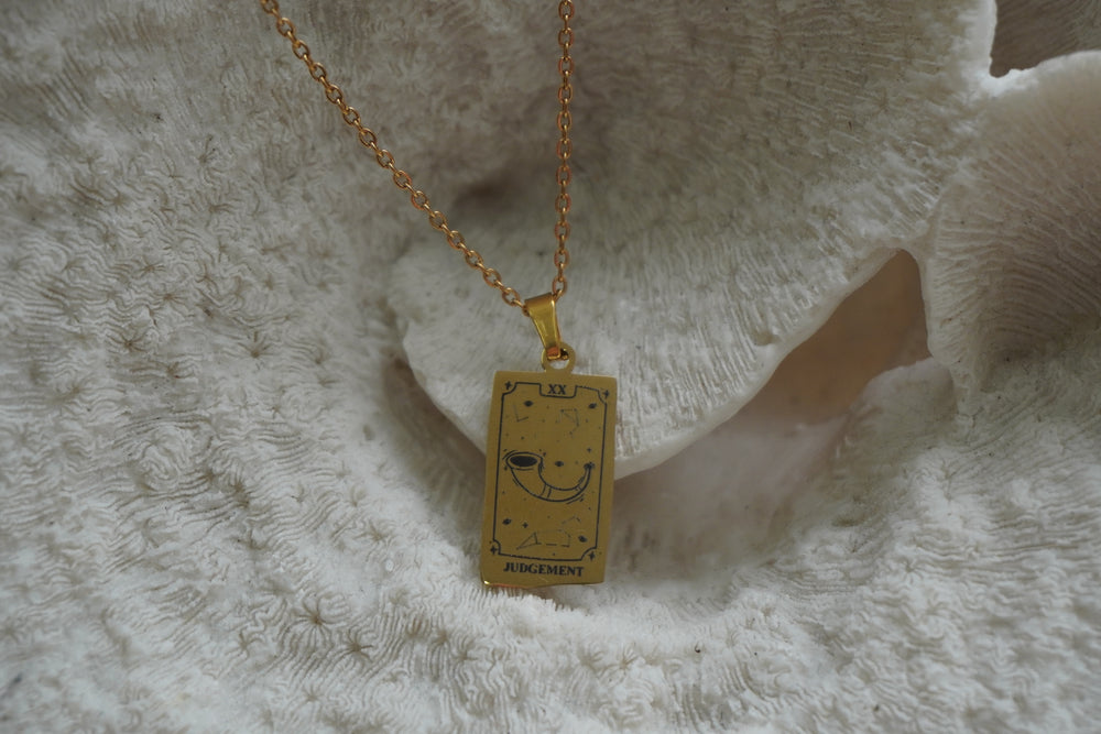 Alternate view: gold-tone necklace with a rectangular Judgement pendant, curved horn, constellation lines and XX lettering.