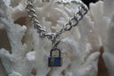 Silver-tone curb-link bracelet with a padlock charm and ring-and-bar clasp.