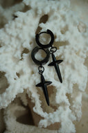 Alternate view: black hoop earrings with elongated pointed cross charms.