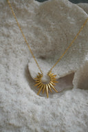 Alternate view: gold-tone necklace with an open crescent-like centre and long radiating points.